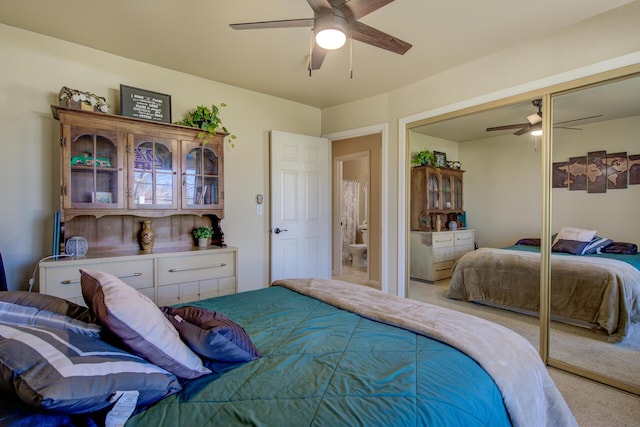 carpeted bedroom featuring ceiling fan and a closet