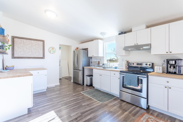 kitchen with dark hardwood / wood-style flooring, white cabinets, lofted ceiling, and appliances with stainless steel finishes