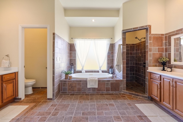 full bathroom with vanity, shower with separate bathtub, and toilet