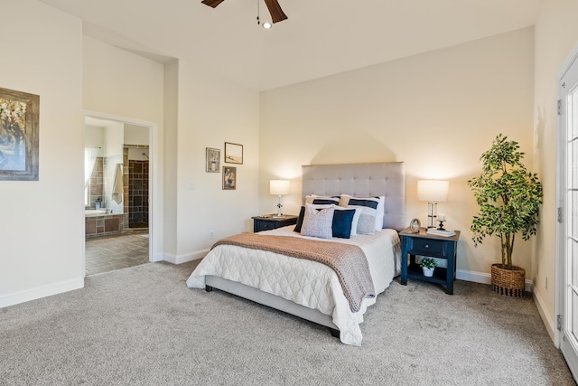 bedroom with ensuite bathroom, ceiling fan, and light colored carpet