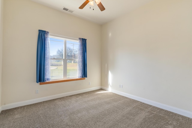 carpeted empty room featuring ceiling fan