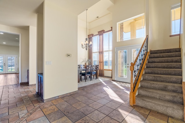 entryway with a notable chandelier and french doors