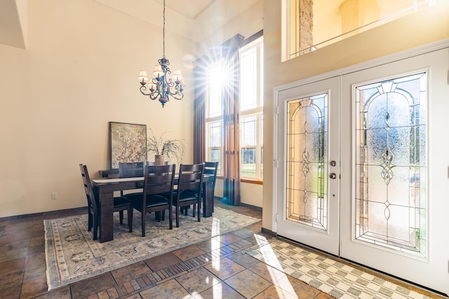 dining area featuring a notable chandelier, plenty of natural light, and french doors