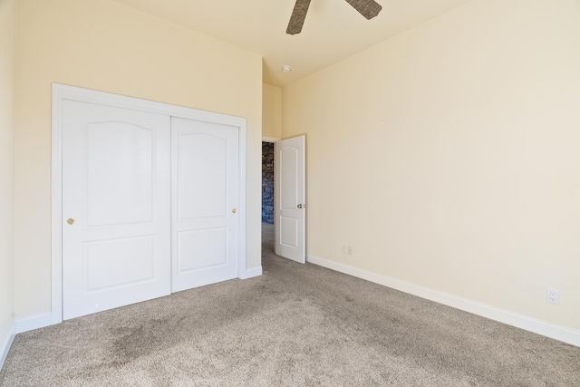 unfurnished bedroom with light carpet, vaulted ceiling, a closet, and ceiling fan