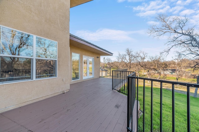 wooden deck featuring a lawn