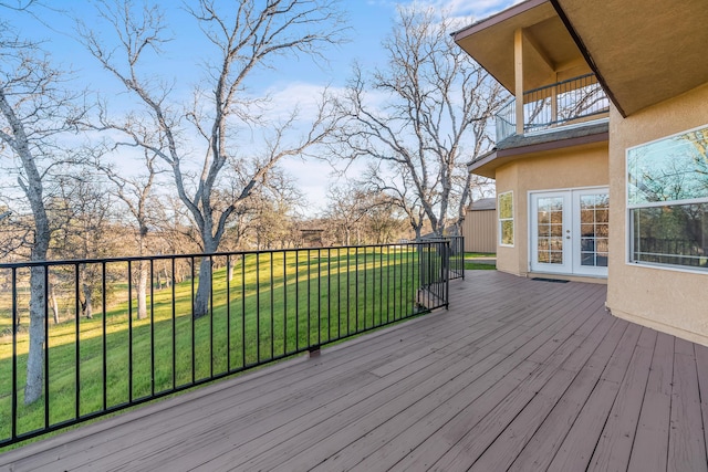 wooden terrace featuring a yard and french doors