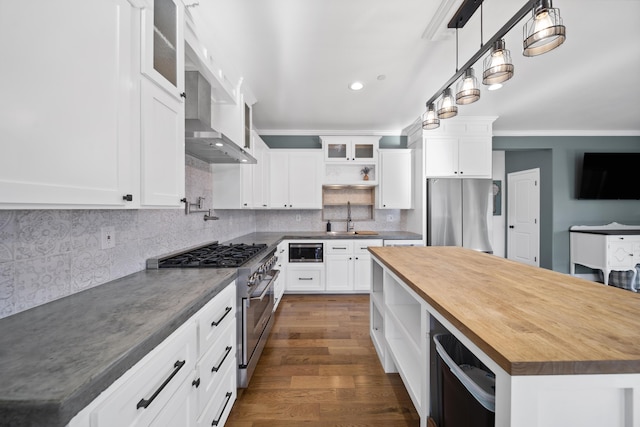 kitchen with sink, white cabinetry, stainless steel appliances, and wood counters