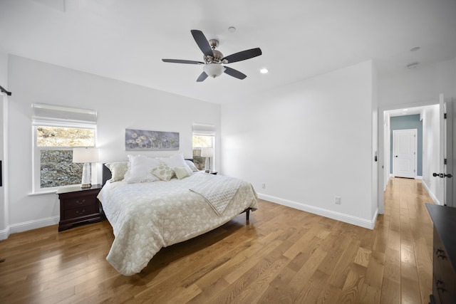 bedroom with ceiling fan and wood-type flooring