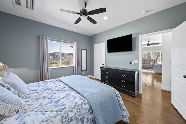 bedroom featuring ceiling fan and dark hardwood / wood-style flooring