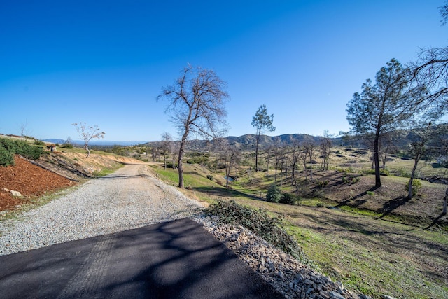 view of street with a mountain view and a rural view