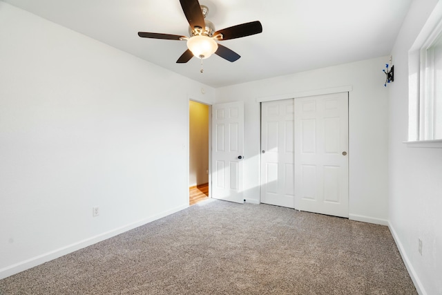 unfurnished bedroom with carpet flooring, ceiling fan, and a closet