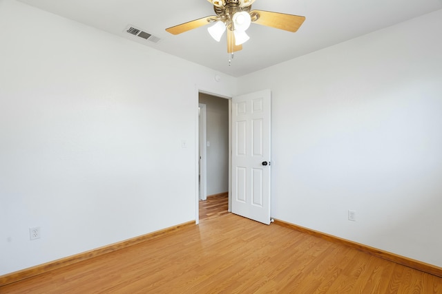 spare room featuring ceiling fan and light hardwood / wood-style flooring