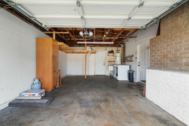 garage featuring a garage door opener, sink, and washer / clothes dryer