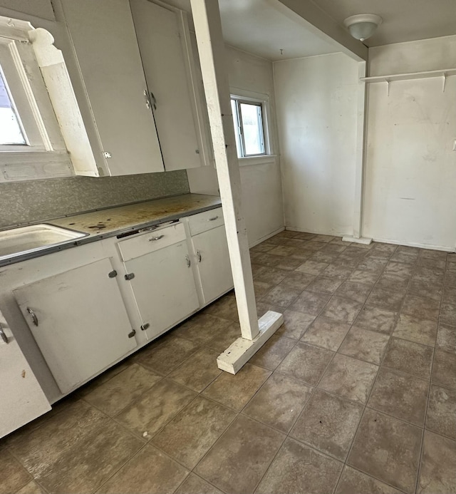 kitchen featuring white cabinets and tasteful backsplash