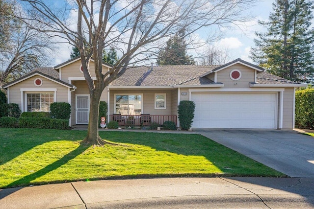 single story home with a porch, a front yard, and a garage