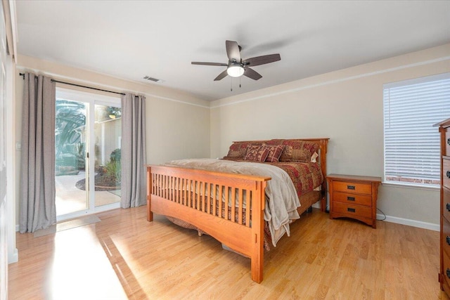 bedroom featuring multiple windows, access to exterior, ceiling fan, and light wood-type flooring