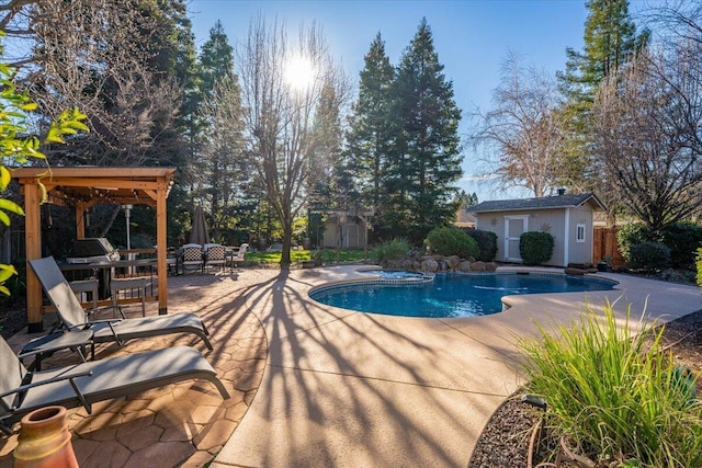 view of swimming pool with an in ground hot tub, a storage unit, and a patio