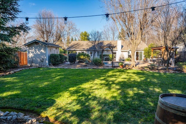 view of yard featuring a storage unit and a pergola