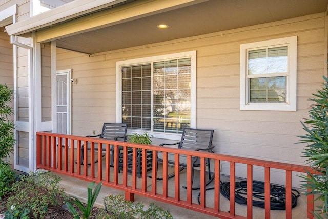 wooden terrace featuring covered porch