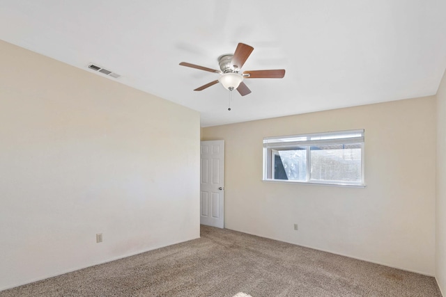 carpeted spare room with ceiling fan