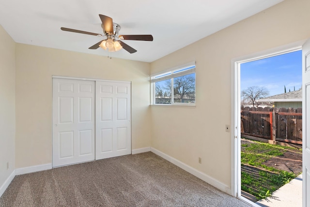 unfurnished bedroom featuring carpet, a closet, and ceiling fan