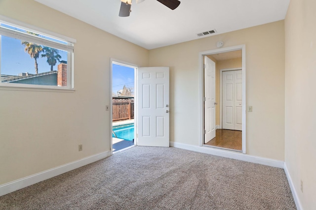 unfurnished bedroom featuring ceiling fan, access to exterior, and carpet floors