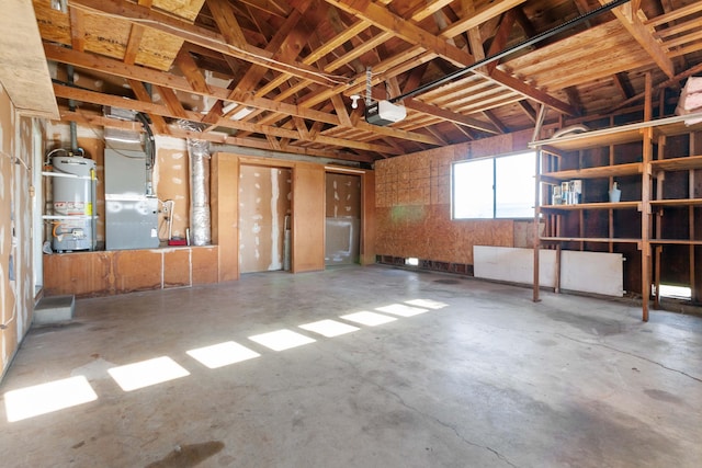 interior space with concrete flooring, heating unit, and water heater