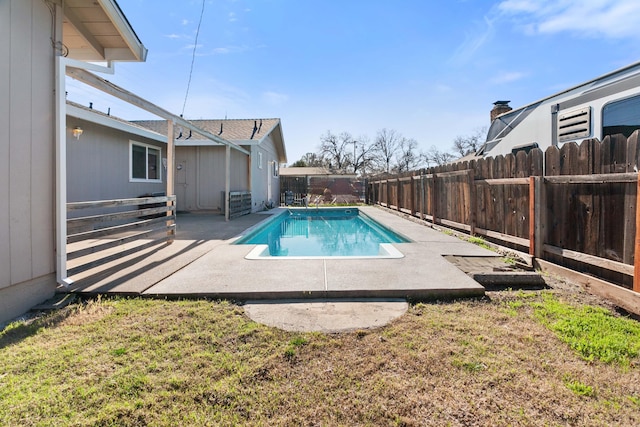 view of swimming pool with a patio area and a yard