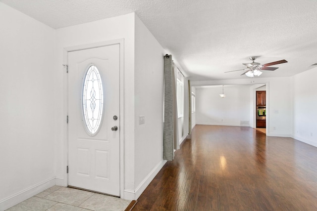 entrance foyer with ceiling fan, plenty of natural light, and a textured ceiling