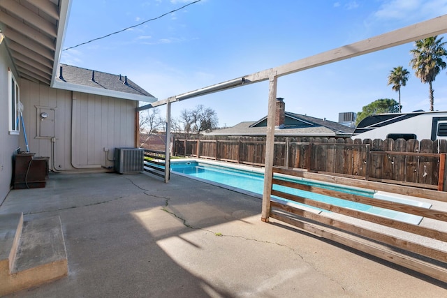 view of pool featuring a patio and central AC