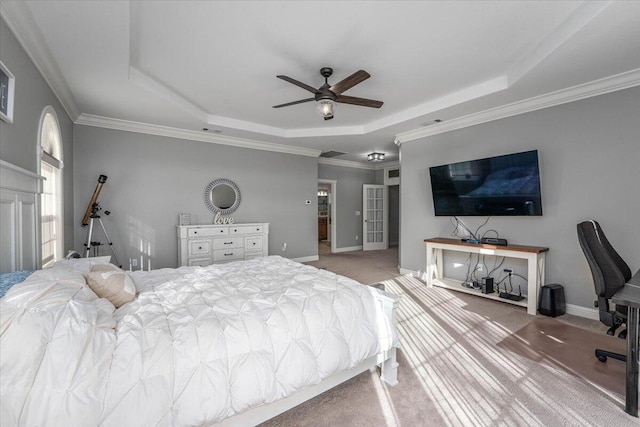 bedroom with ceiling fan, carpet flooring, crown molding, and a raised ceiling