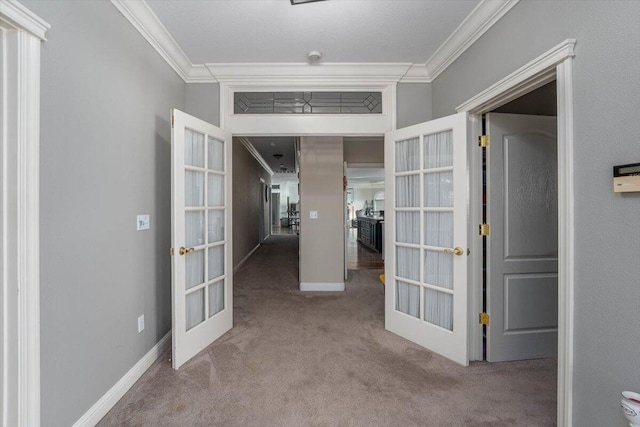 hall featuring light carpet, ornamental molding, and french doors