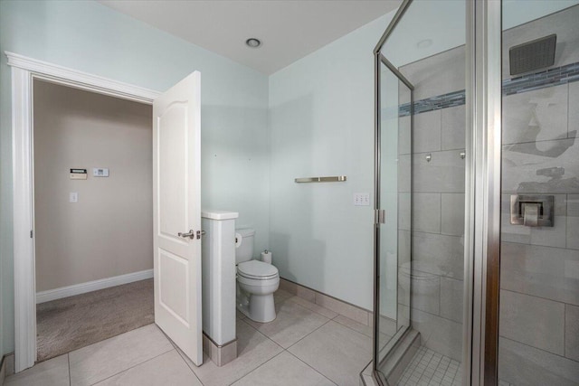 bathroom featuring tile patterned floors, walk in shower, and toilet