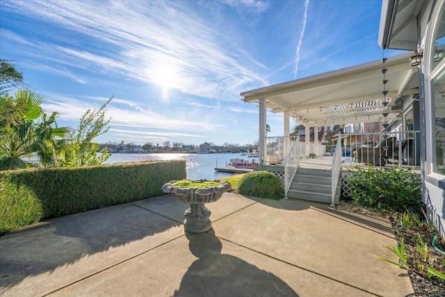 view of patio featuring a pergola and a water view