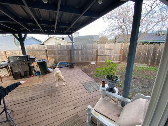 wooden deck with a grill