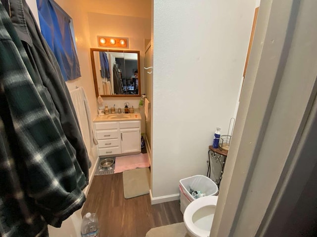 bathroom with vanity, hardwood / wood-style floors, and toilet