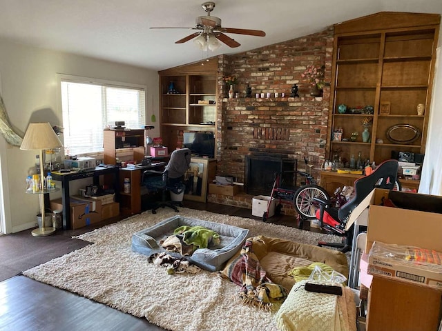 office space featuring dark wood-type flooring, ceiling fan, a fireplace, and vaulted ceiling