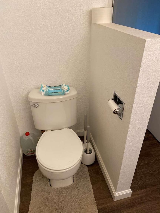 bathroom featuring hardwood / wood-style flooring and toilet