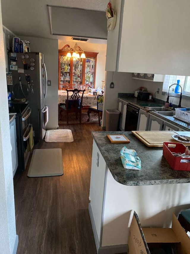 kitchen with sink, double oven range, dark hardwood / wood-style floors, and black dishwasher