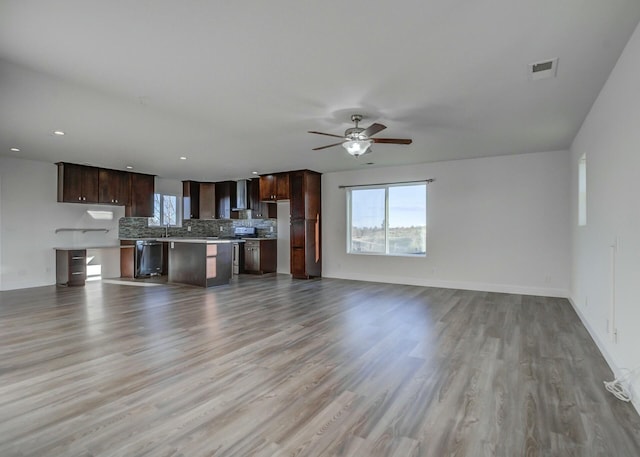 unfurnished living room with light hardwood / wood-style floors and ceiling fan