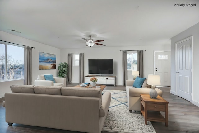 living room with ceiling fan and dark hardwood / wood-style flooring