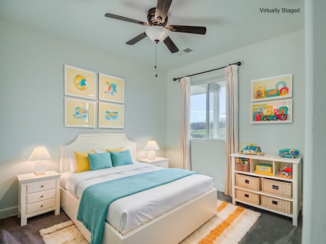 bedroom featuring dark colored carpet and ceiling fan