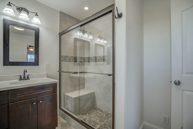 bathroom with vanity and a shower with door