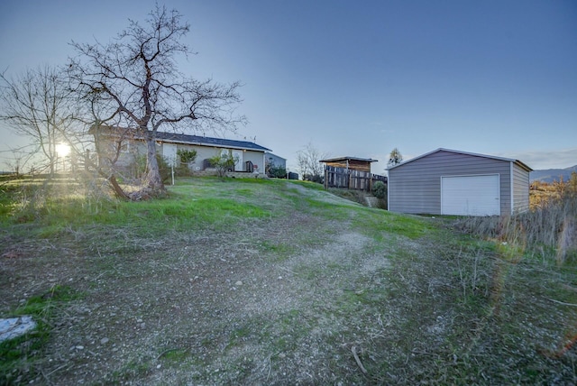 view of yard with an outdoor structure and a garage