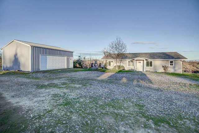 view of front of house with an outdoor structure and a garage