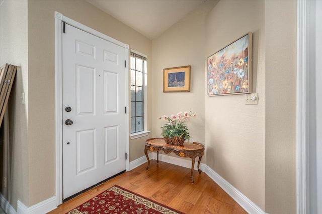 entrance foyer with light hardwood / wood-style floors and vaulted ceiling