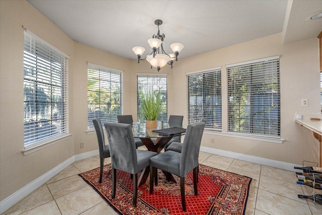 tiled dining area featuring an inviting chandelier