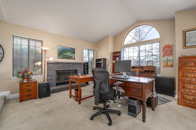 carpeted home office with vaulted ceiling, a fireplace, and plenty of natural light