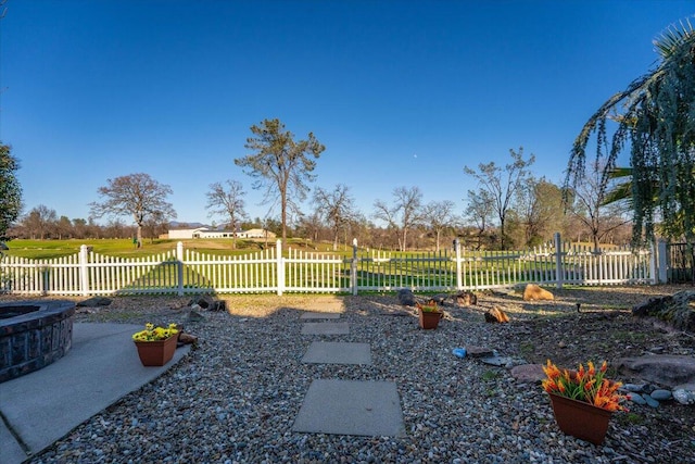 view of yard featuring an outdoor fire pit