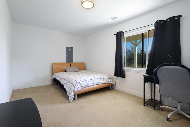 bedroom featuring light colored carpet and electric panel